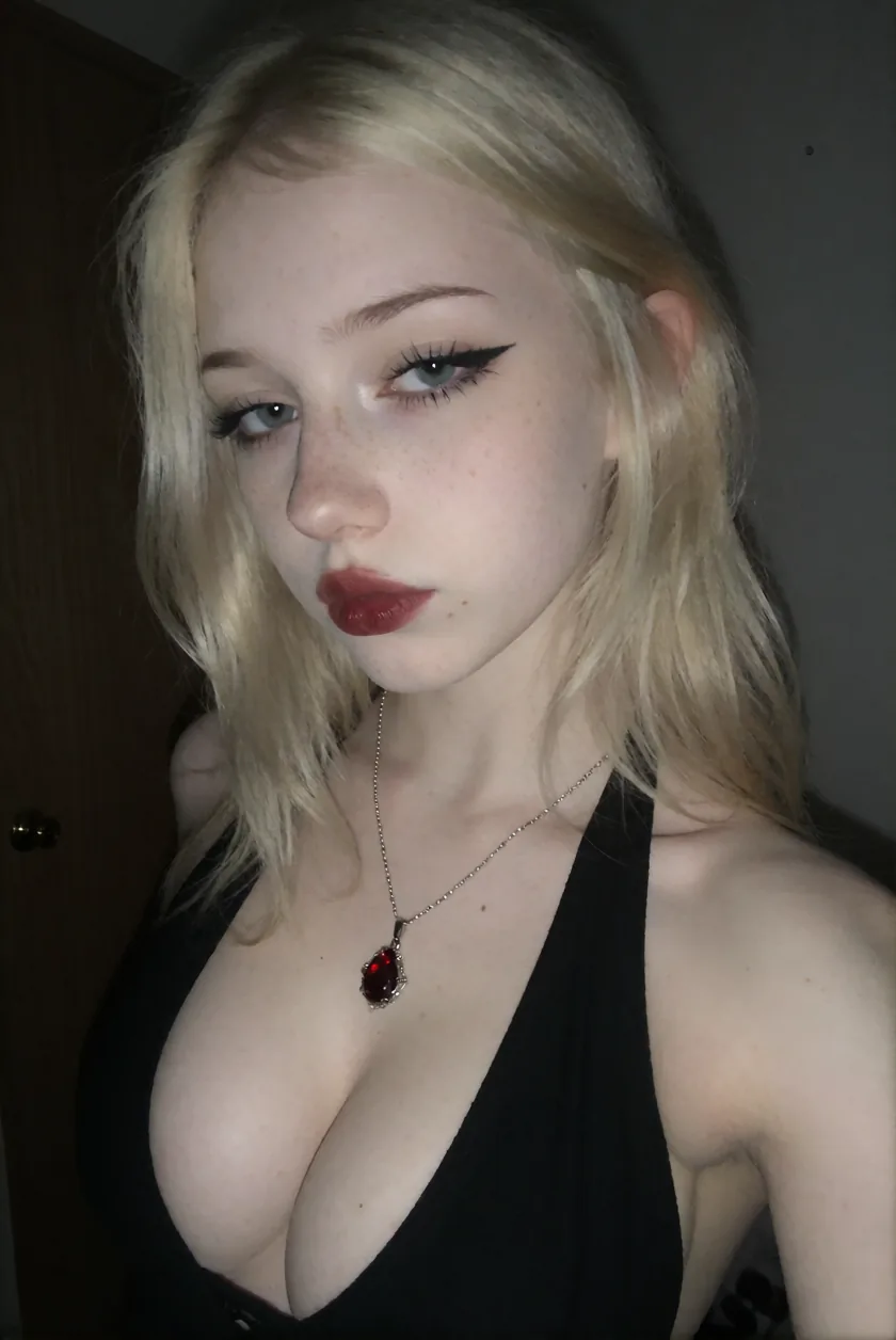 Adult blonde woman in a dark portrait